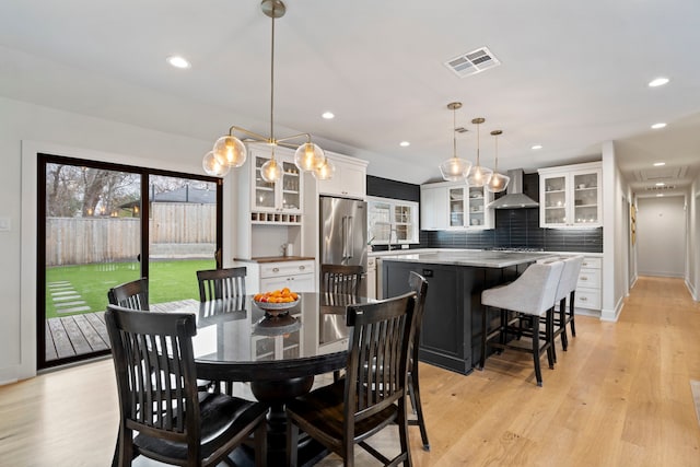 dining space featuring sink and light wood-type flooring