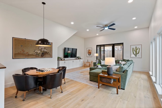 living room featuring ceiling fan and light hardwood / wood-style flooring