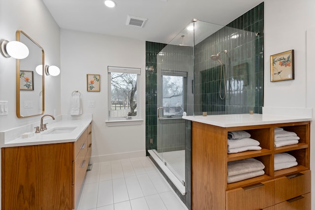 bathroom featuring vanity, tile patterned floors, and walk in shower