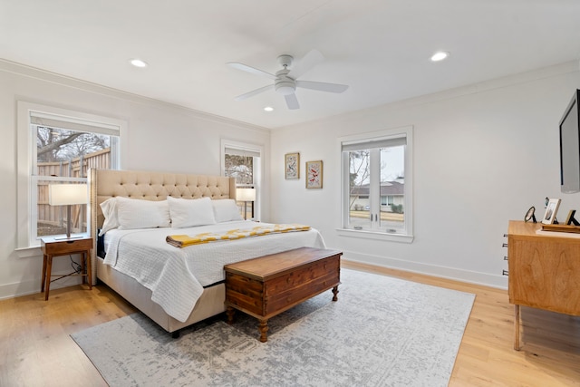 bedroom featuring crown molding, ceiling fan, and light wood-type flooring