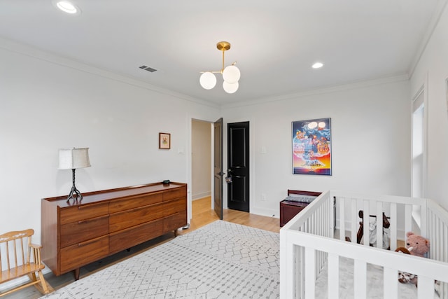 bedroom featuring crown molding, wood-type flooring, and a chandelier