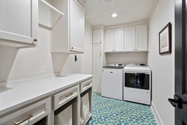 laundry room featuring cabinets and washing machine and dryer