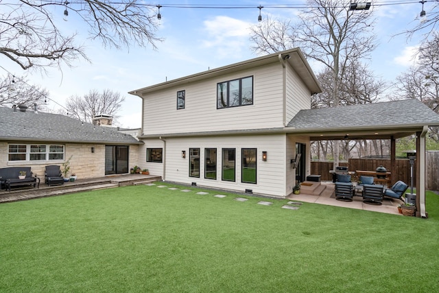 rear view of house featuring outdoor lounge area, a patio, and a lawn