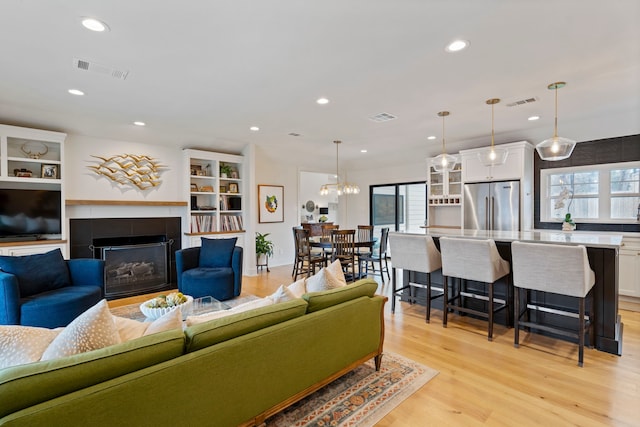 living room featuring a fireplace and light hardwood / wood-style flooring