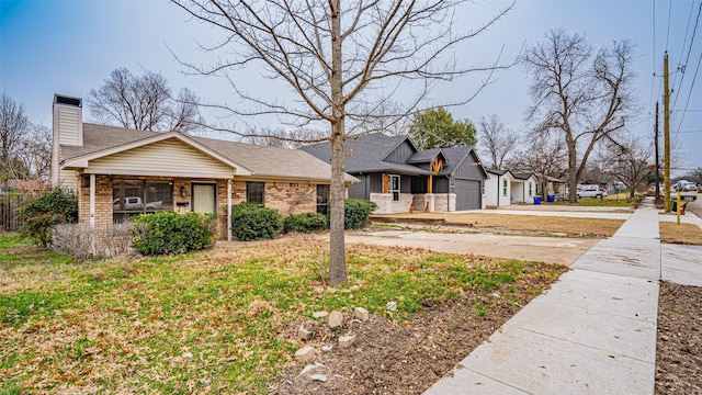 view of front of property featuring a garage, driveway, a chimney, and brick siding