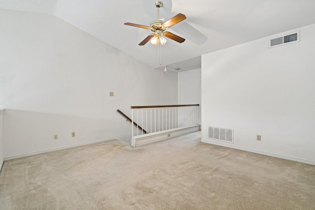 carpeted empty room with ceiling fan and lofted ceiling