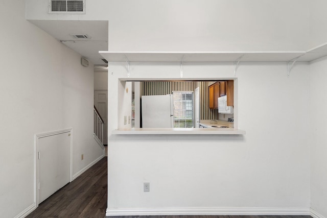 kitchen featuring dark wood-type flooring and white appliances