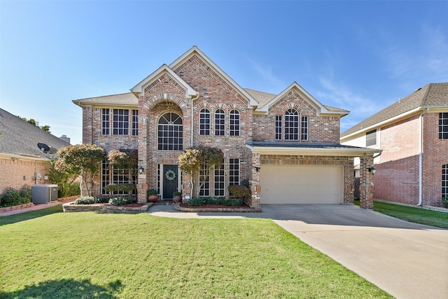 view of front facade featuring a garage, a front yard, and central AC unit