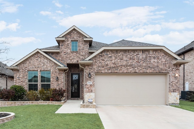 view of front of property with a garage, a front lawn, and central air condition unit