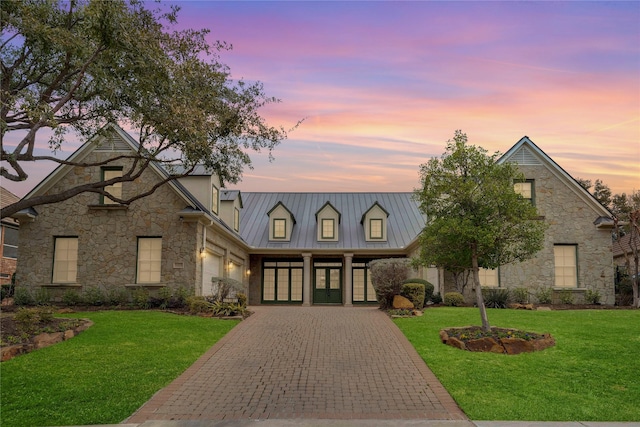 view of front of property featuring a garage and a yard