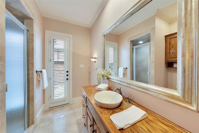 bathroom with crown molding, a wealth of natural light, vanity, and a shower with shower door