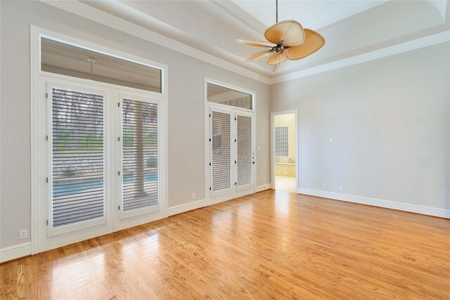 unfurnished room with crown molding, ceiling fan, and light hardwood / wood-style flooring