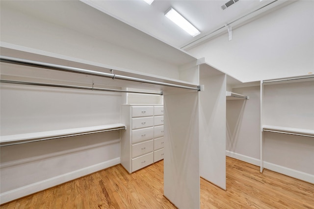 spacious closet with light hardwood / wood-style flooring