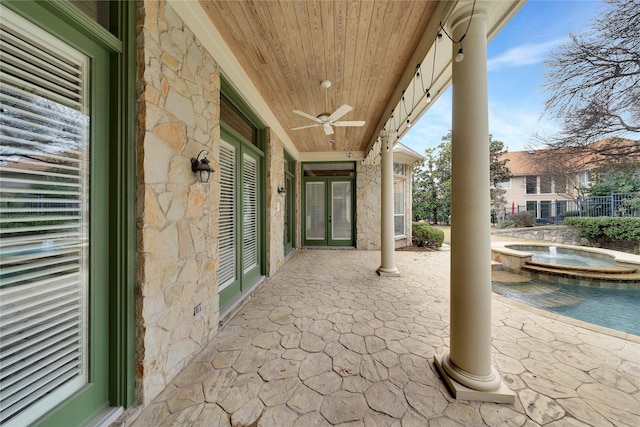 view of patio featuring an in ground hot tub and ceiling fan