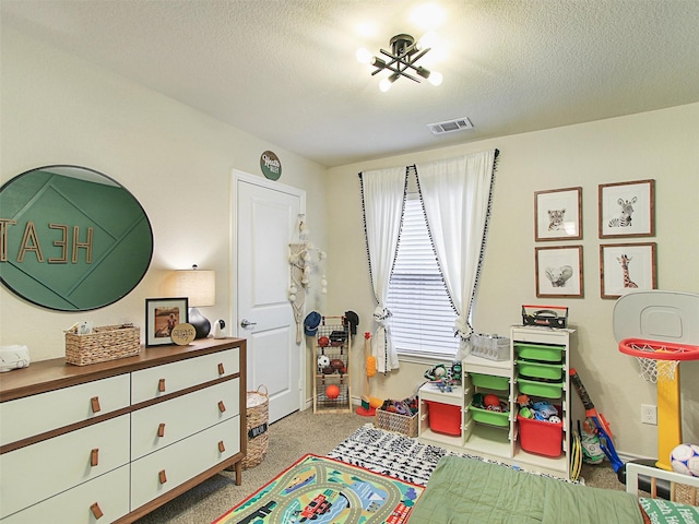 recreation room featuring a textured ceiling and carpet