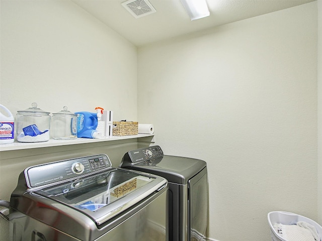 clothes washing area featuring separate washer and dryer