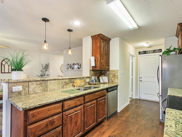 kitchen featuring sink, light stone counters, tasteful backsplash, decorative light fixtures, and dishwasher