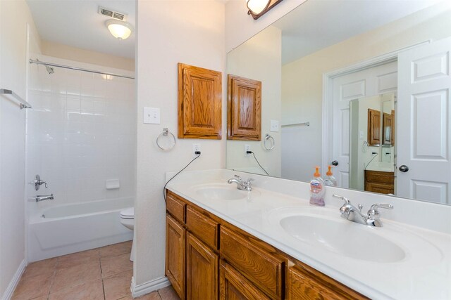 full bathroom with shower / tub combination, vanity, toilet, and tile patterned flooring