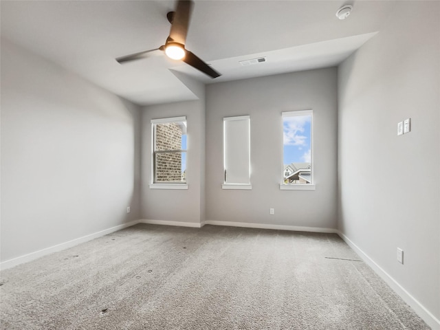 empty room featuring carpet flooring and ceiling fan