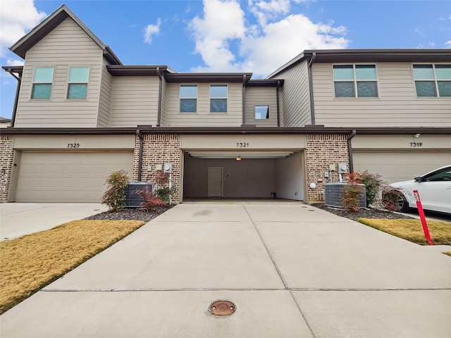 townhome / multi-family property featuring a garage and central AC