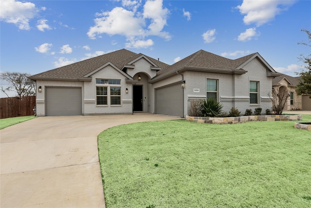 view of front of house with a garage and a front yard