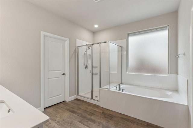 bathroom featuring independent shower and bath and wood-type flooring