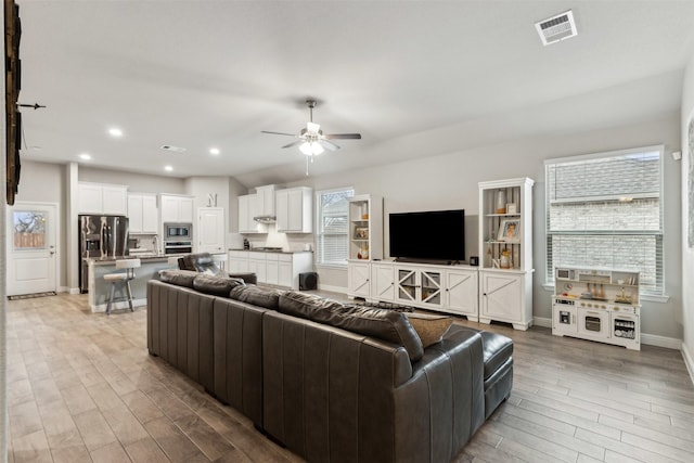 living room with ceiling fan and hardwood / wood-style floors