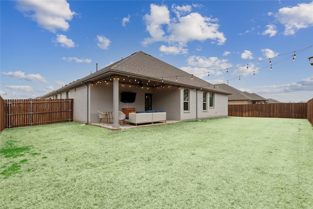 rear view of house featuring an outdoor living space, a lawn, and a patio