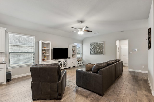 living room featuring ceiling fan and hardwood / wood-style floors