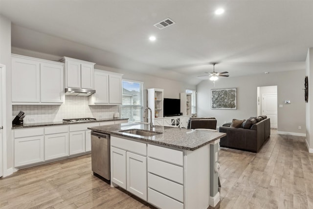 kitchen with white cabinetry, sink, stainless steel appliances, and a center island with sink