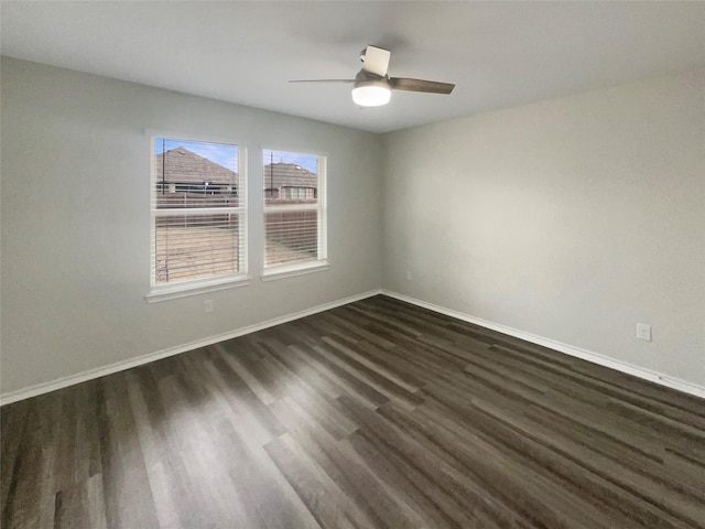 spare room featuring ceiling fan and dark hardwood / wood-style flooring