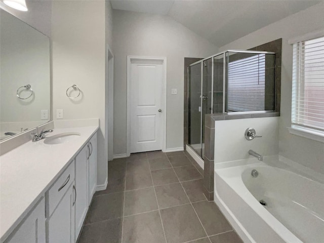 bathroom with independent shower and bath, vanity, lofted ceiling, and tile patterned floors