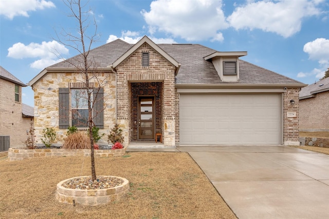 view of front of house featuring a garage, a front lawn, and central air condition unit