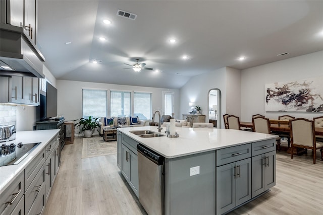 kitchen featuring gray cabinets, dishwasher, sink, a kitchen island with sink, and black electric stovetop