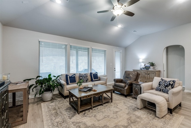 living room with ceiling fan, lofted ceiling, and light hardwood / wood-style flooring