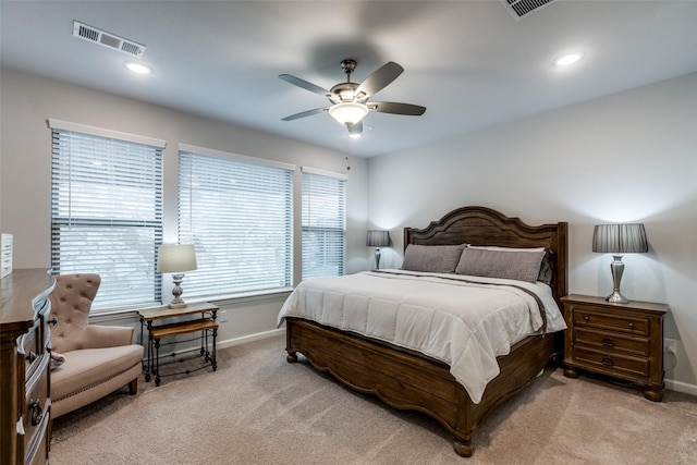 bedroom with ceiling fan and light carpet