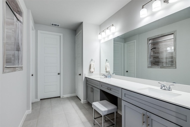 bathroom featuring tile patterned flooring and vanity