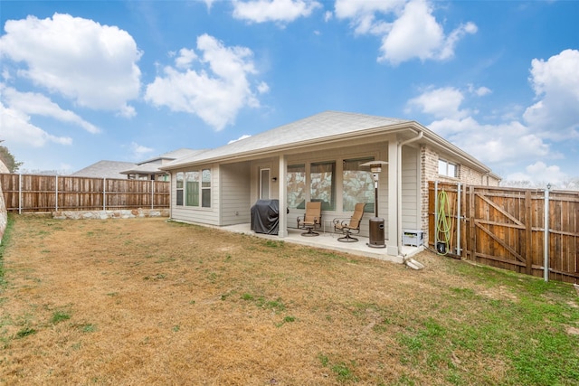 back of house with a patio and a yard