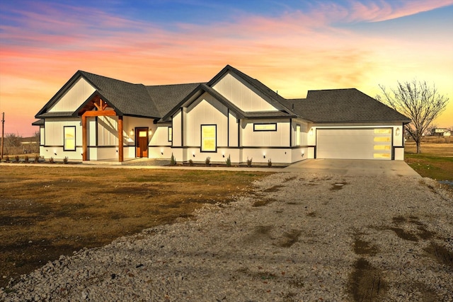 view of front of house featuring a garage and a yard