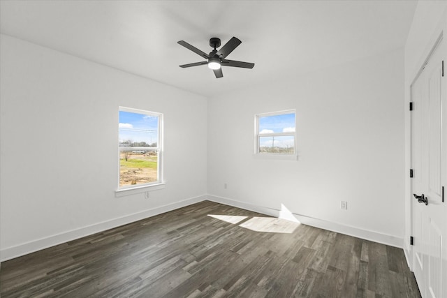 spare room featuring ceiling fan and dark hardwood / wood-style flooring