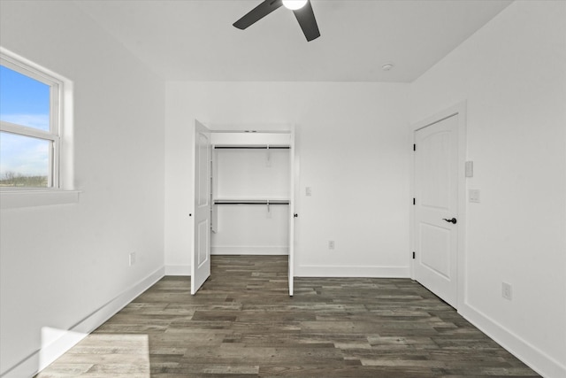 unfurnished bedroom with ceiling fan, dark hardwood / wood-style floors, and a closet