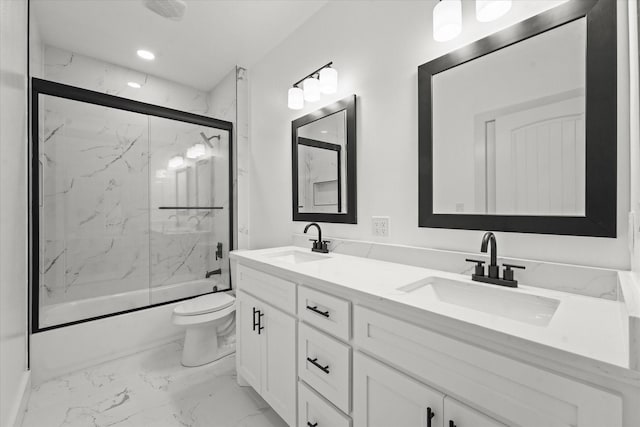 full bathroom featuring vanity, shower / bath combination with glass door, and toilet