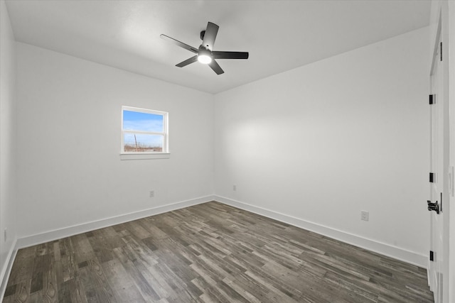 spare room with ceiling fan and dark hardwood / wood-style flooring