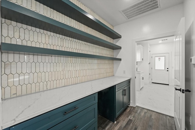 kitchen with light stone countertops and dark wood-type flooring