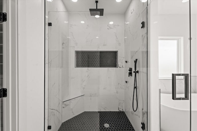 bathroom featuring shower with separate bathtub