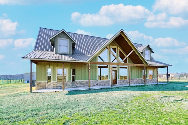 view of front facade with stone siding, metal roof, and board and batten siding