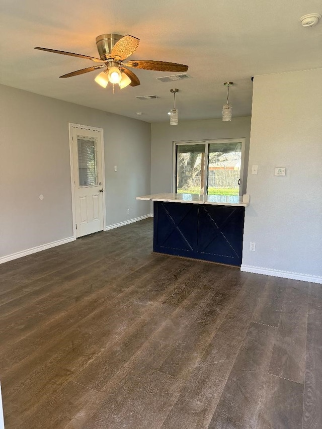 unfurnished living room with ceiling fan and dark hardwood / wood-style floors