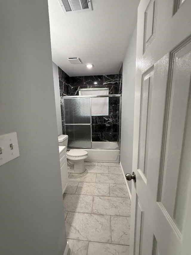 full bathroom with shower / bath combination with glass door, vanity, and toilet