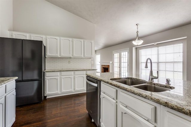 kitchen with sink, refrigerator, hanging light fixtures, dishwasher, and white cabinets