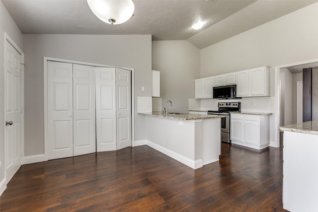 kitchen with stainless steel electric stove, white cabinetry, sink, light stone counters, and kitchen peninsula